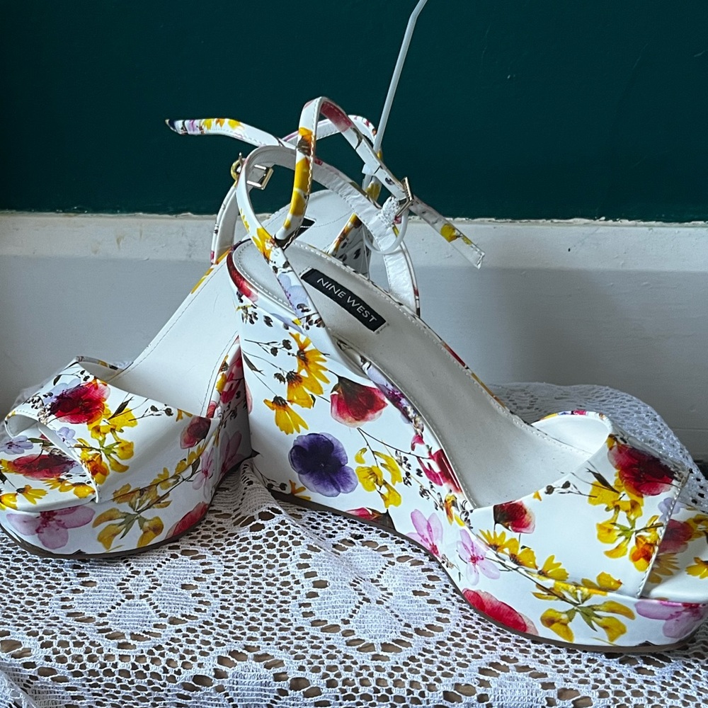 Nine west wedges in yellow red purple floral design with white backdrop